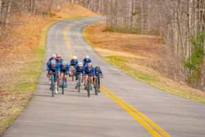 Road cyclists racing on road in the fall.