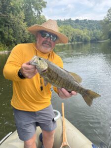Jay Waide, owner of Roanoke Angler, on the water holding a large fish.