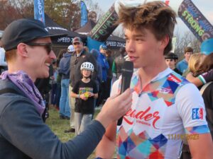 Person interviewing local teen cyclist Henry Schumm after a bike race.